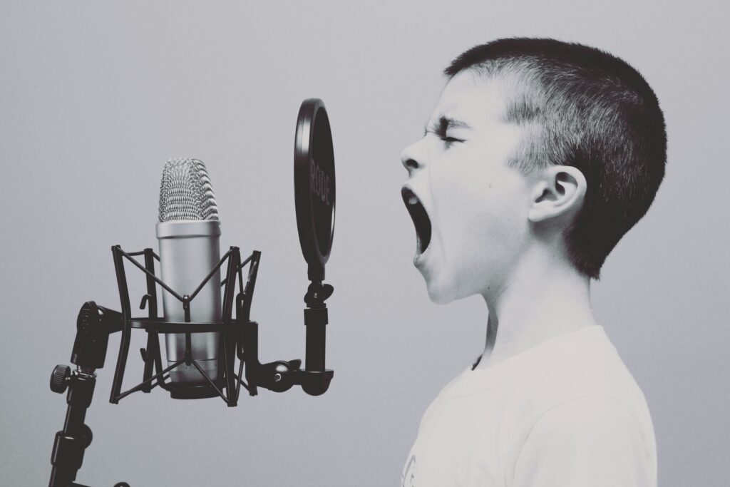 kid singing in microphone